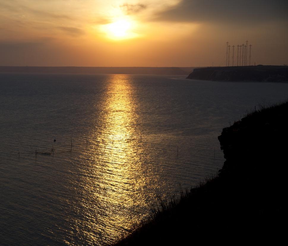 Free Image of A sunset over a body of water 