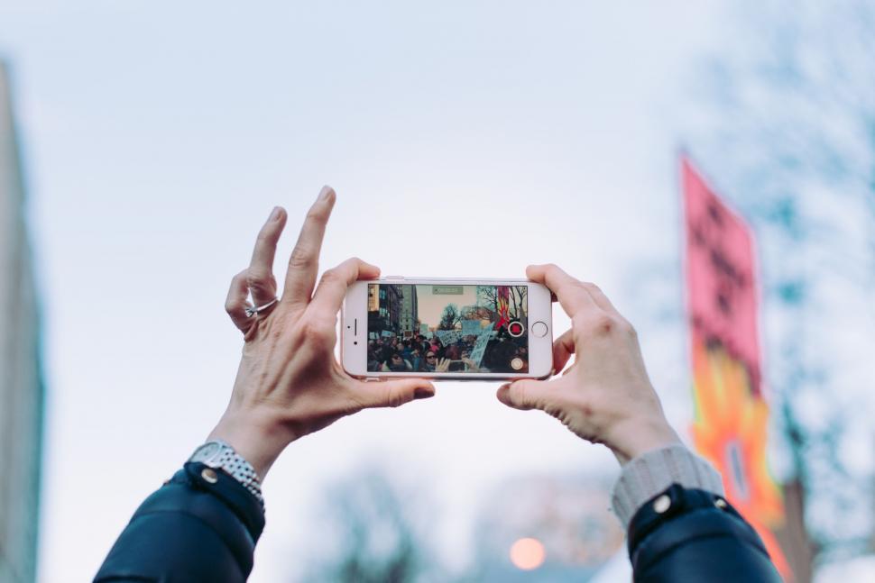 Free Image of A person holding a phone with a screen 