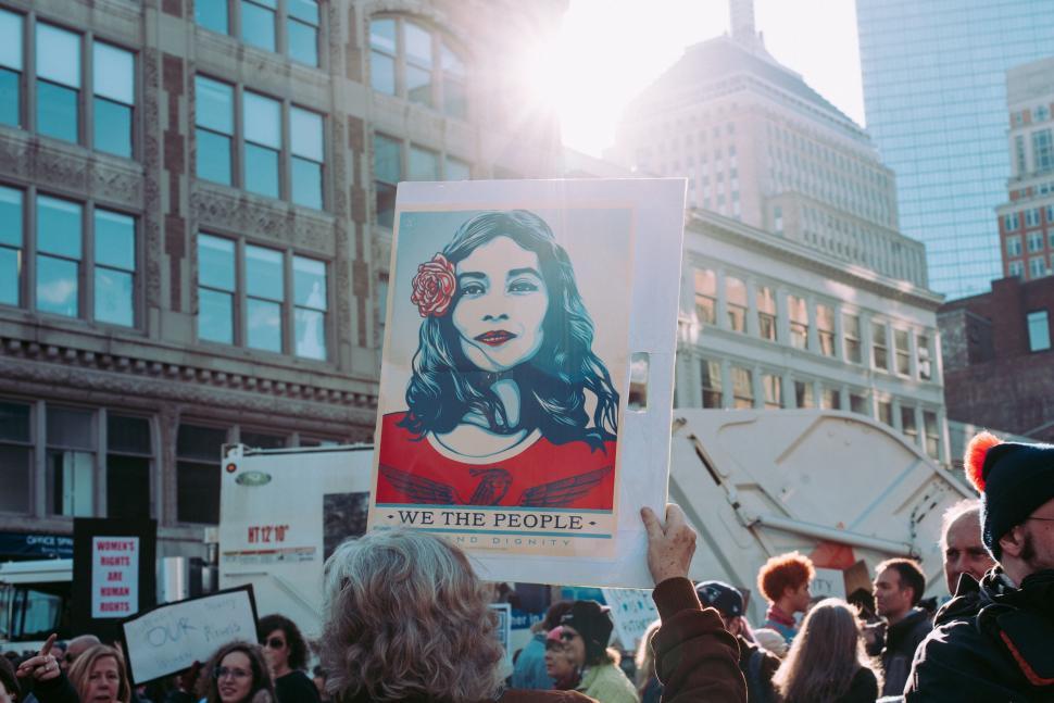Free Image of A group of people holding up a poster 