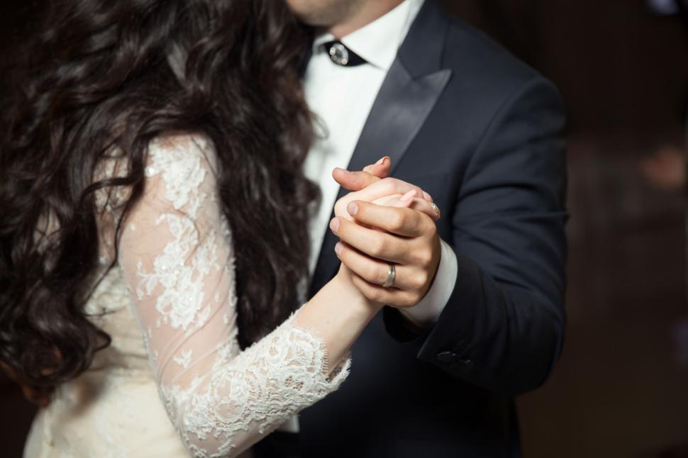 Free Image of A man and woman holding hands 
