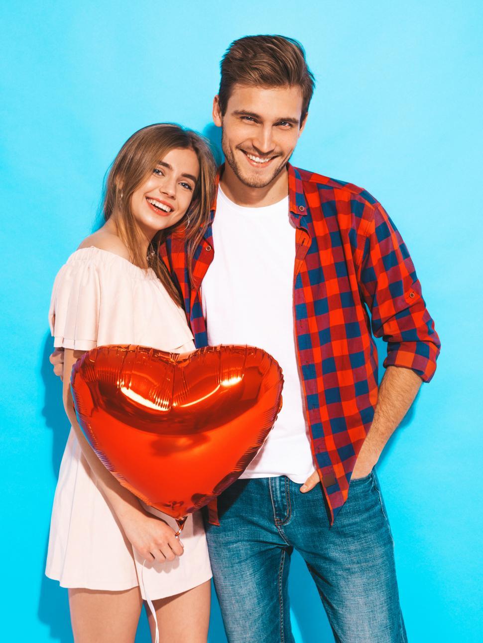 Free Image of A man and woman holding a balloon 