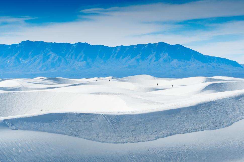 Free Image of A snow covered hills with a mountain in the background 