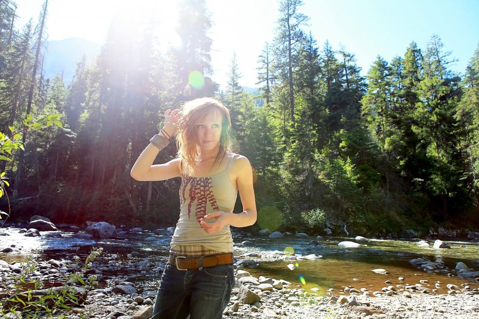 Free Image of A woman standing in front of a river 