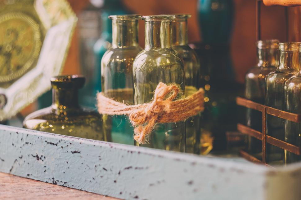 Free Image of A group of glass bottles tied with a rope 