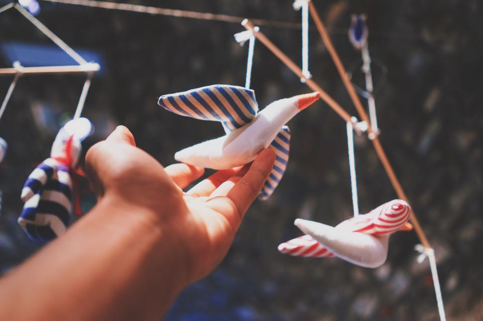 Free Image of A hand holding a toy bird 