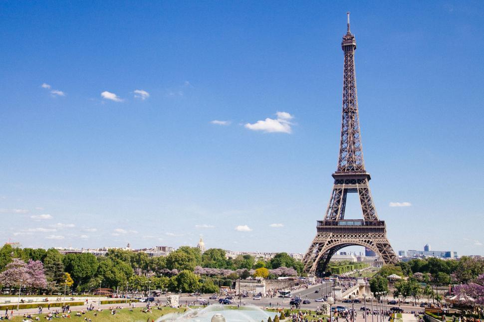 Free Image of A tall metal tower with people walking around 