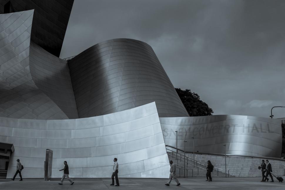 Free Image of A group of people walking in front of a building 