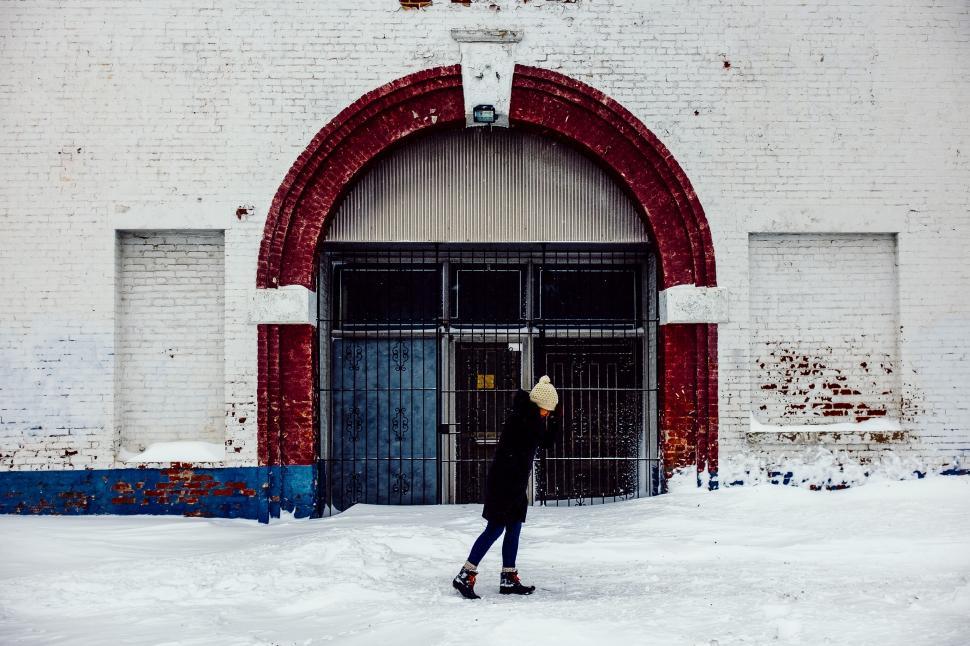 Free Image of A woman walking in the snow 