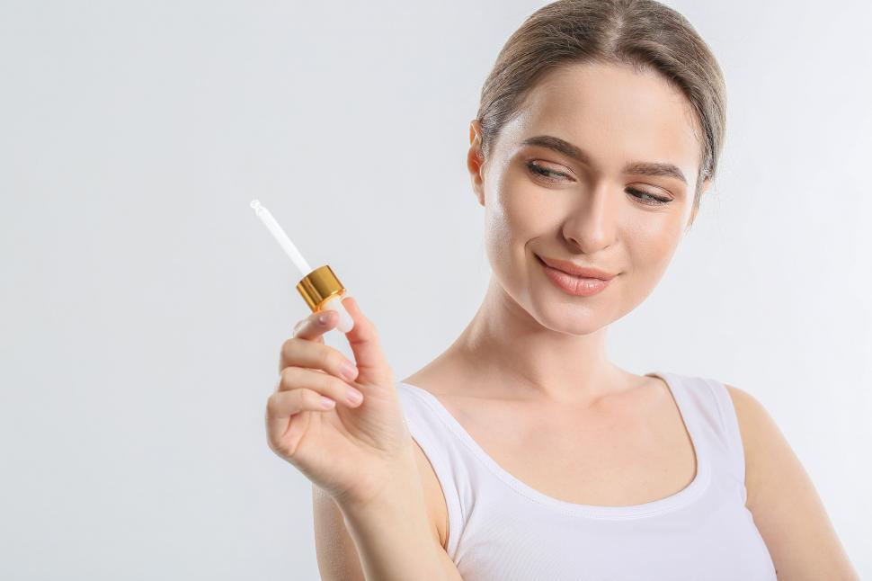 Free Image of A woman holding a dropper 