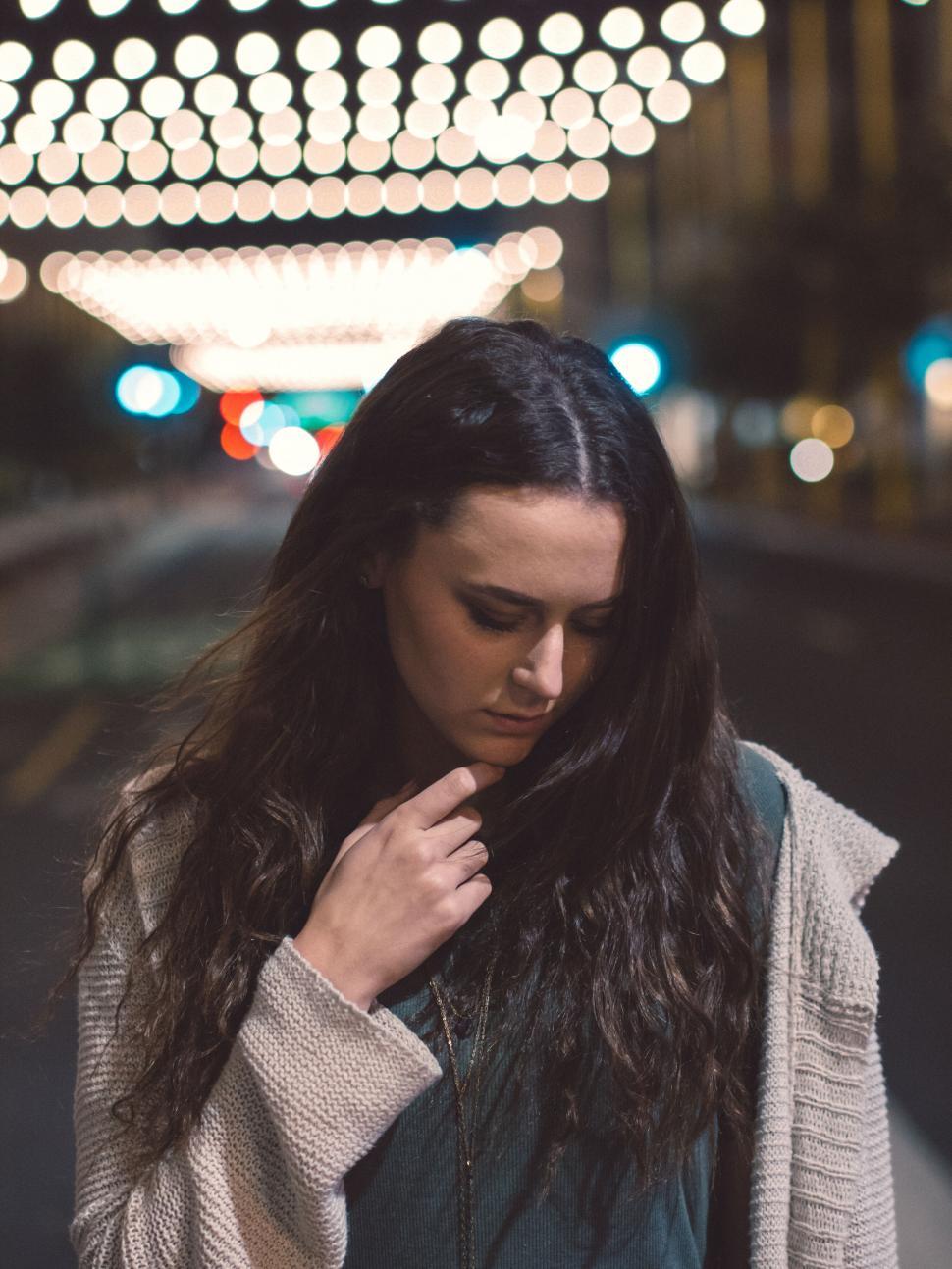 Free Image of A woman looking down at her chin 