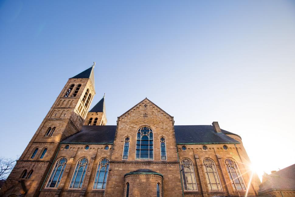 Free Image of Historic church basking in golden sunlight 