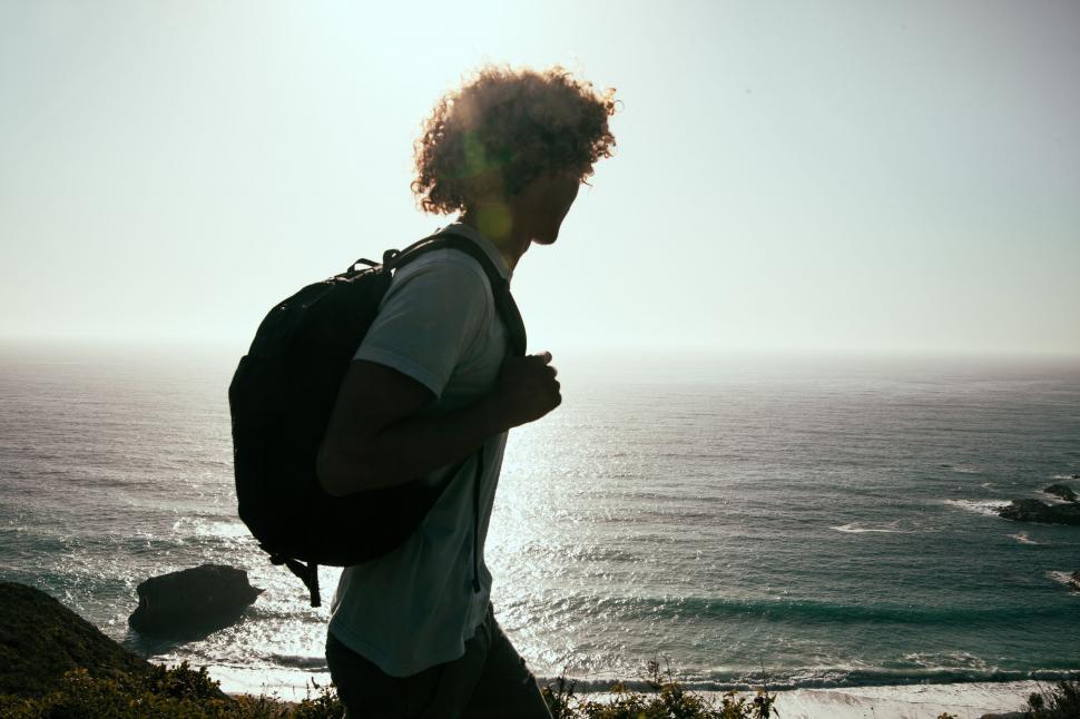 Free Image of Silhouette of hiker overlooking ocean 