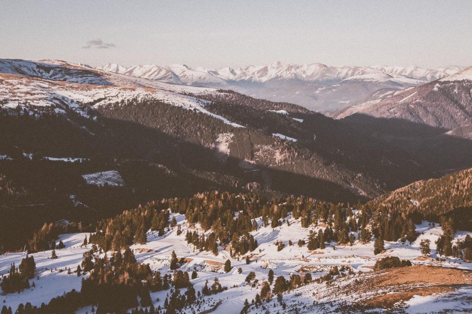Free Image of Snowy village nestled in mountain valley 