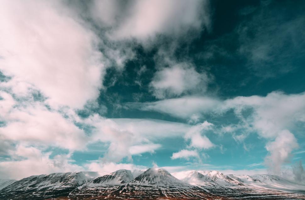 Free Image of Snow-capped mountain under expansive blue sky 