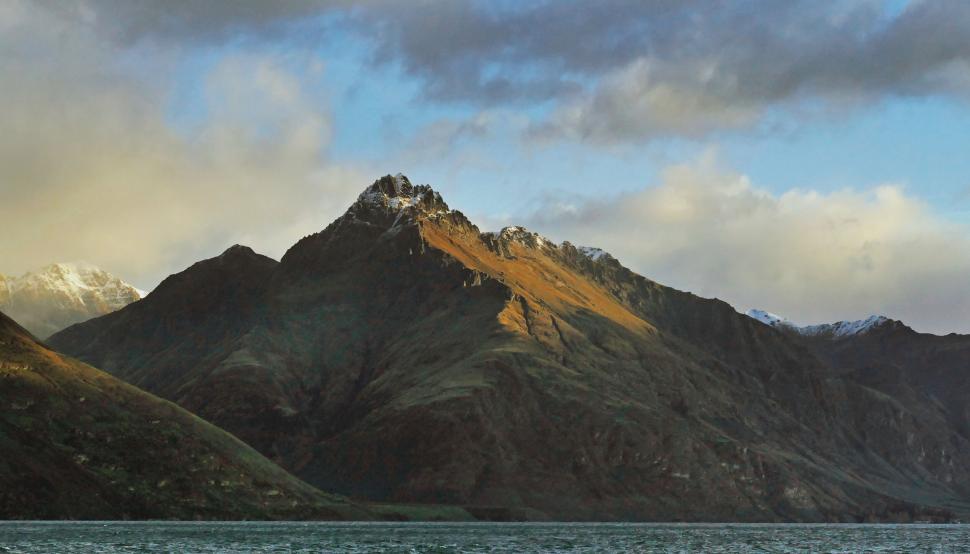 Free Image of Majestic mountain peak under a dramatic sky 