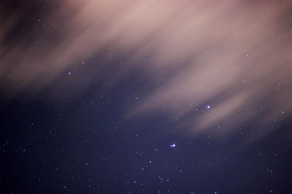 Free Image of Starry night sky with a visible meteor 