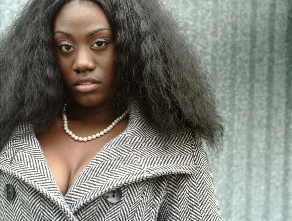 Free Image of Woman in herringbone coat and pearl necklace 