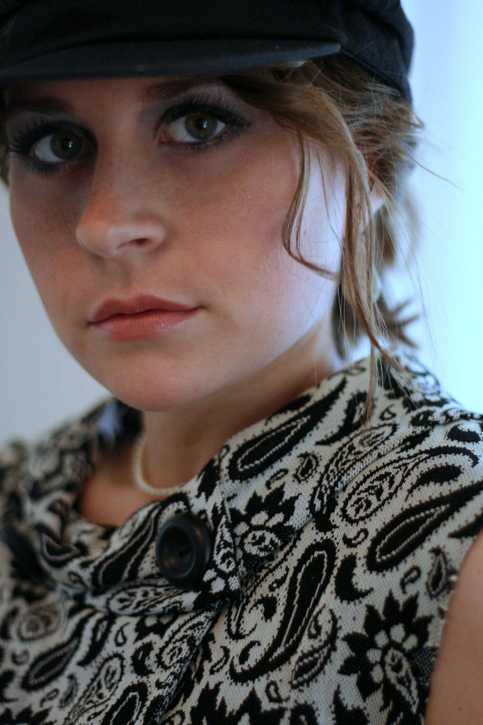 Free Image of Woman with retro style and cap looking pensive 