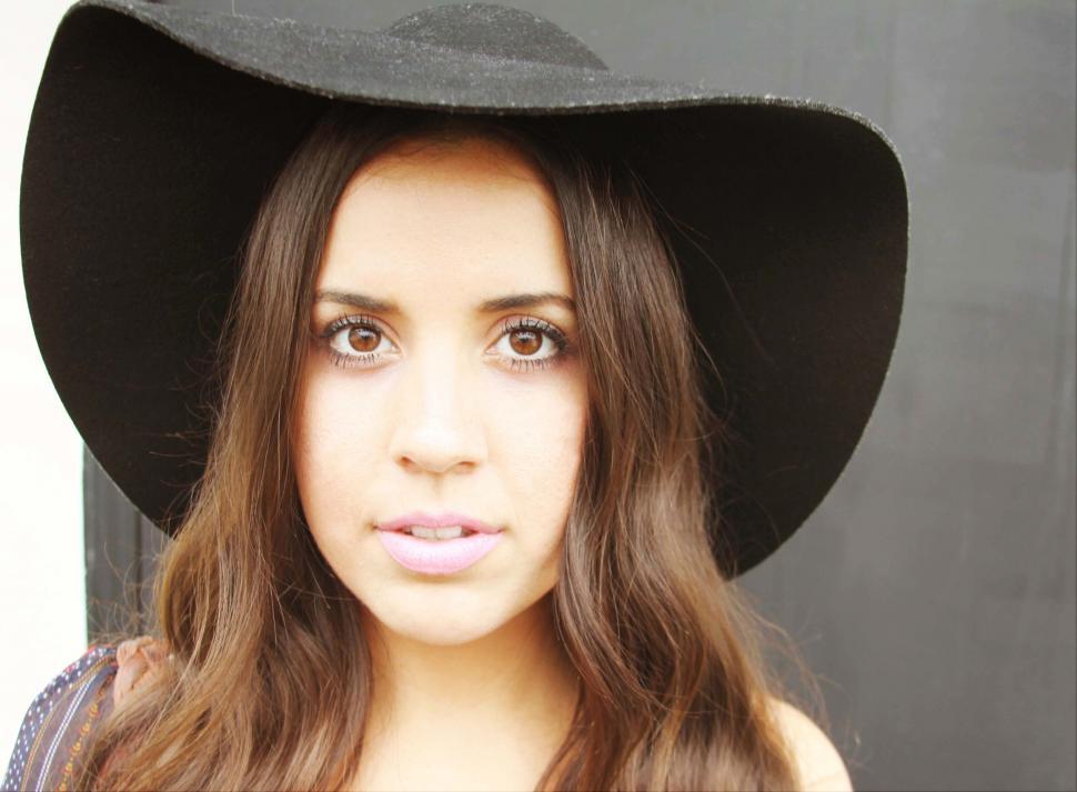 Free Image of Woman with hat giving intense look 