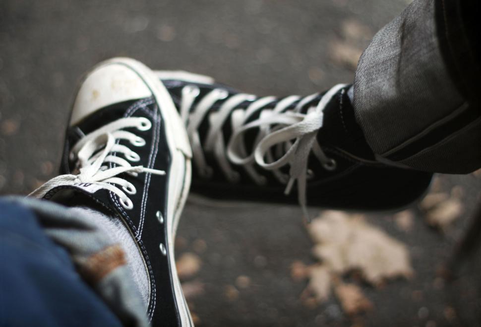 Free Image of Casual shoes on pavement autumn setting 