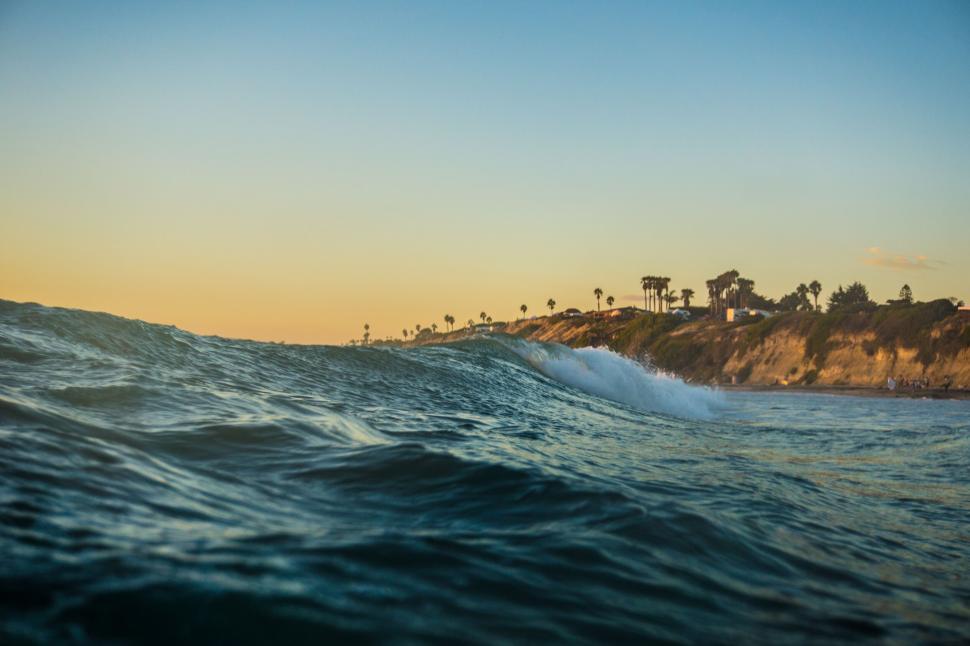 Free Image of Golden hour seascape with waves and shoreline 