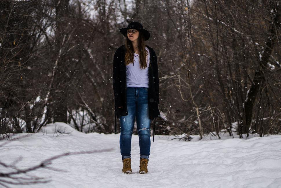 Free Image of Woman standing in snowy woodland 