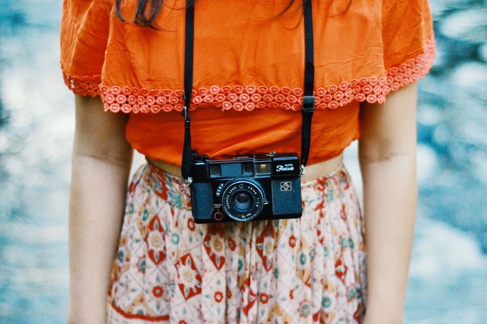vintage-camera-hanging-on-woman-s-torso.jpg
