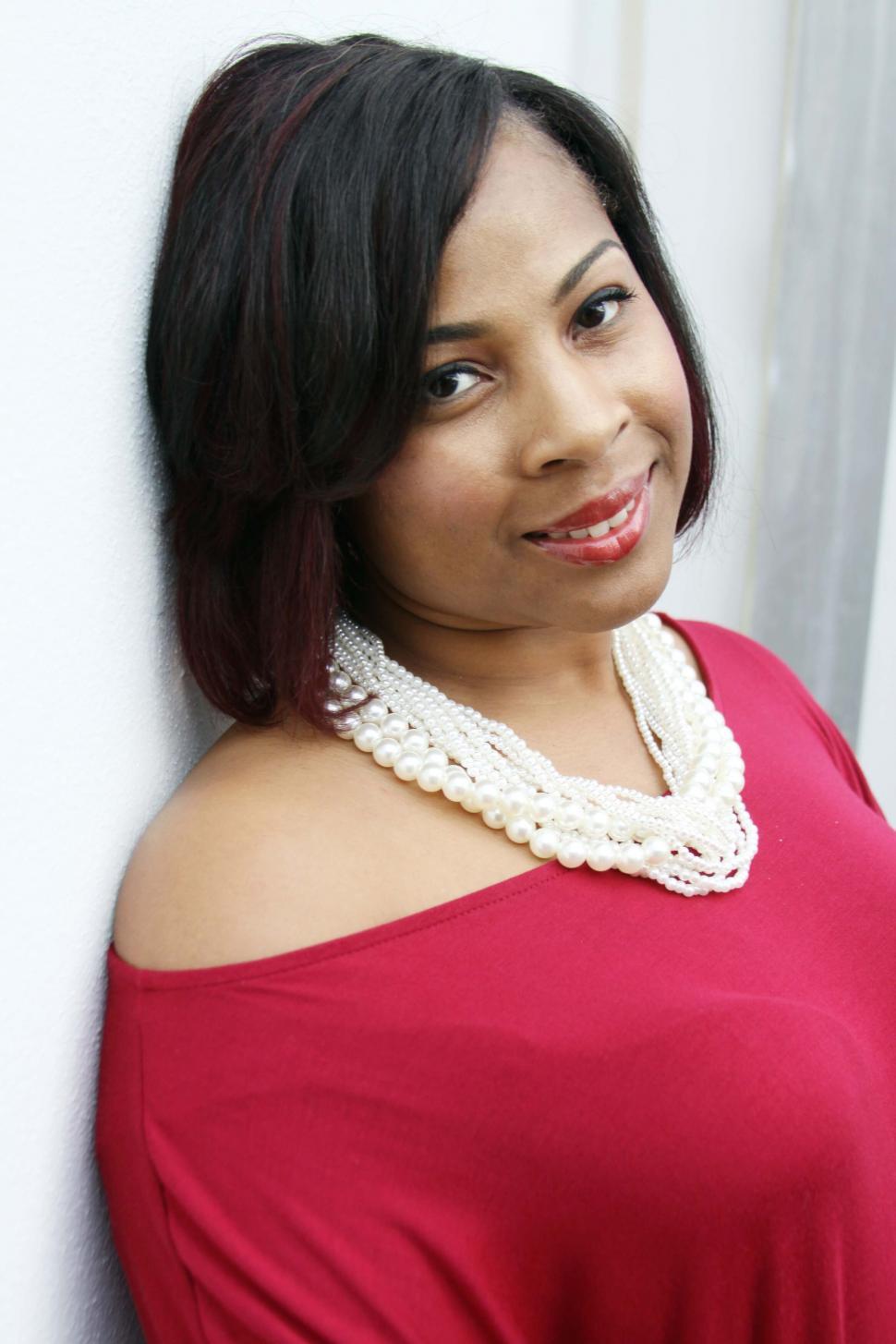 Free Image of Woman in red with pearl necklace 