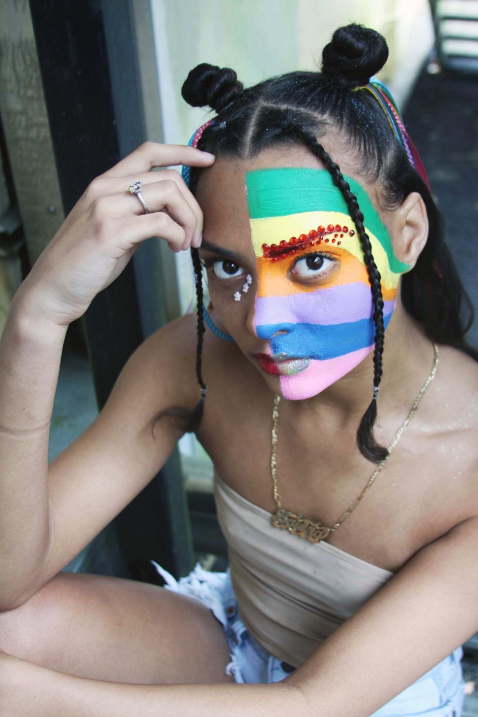 Free Image of Vibrant face painting portrait outdoors 