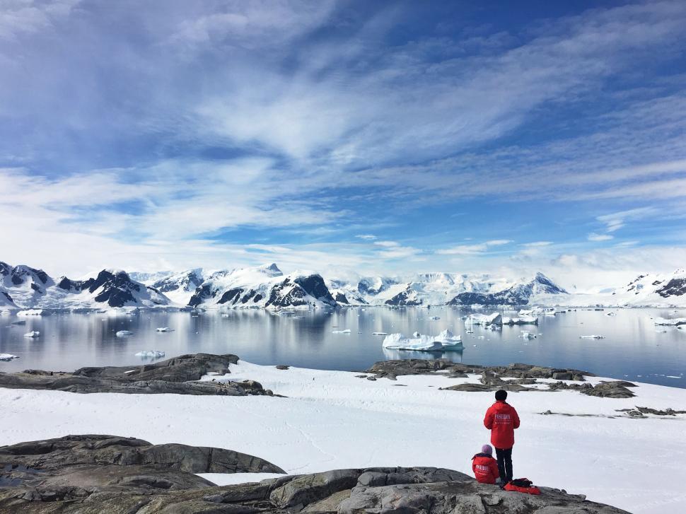 Free Image of Man in red overlooking snowy mountains 