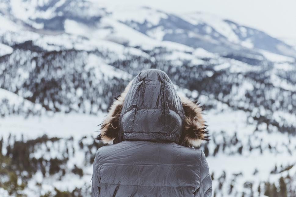 Free Image of Contemplative figure facing snowy mountain 