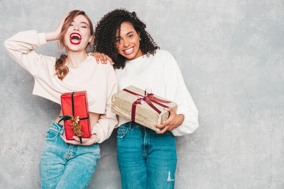 Free Image of Two women holding presents 