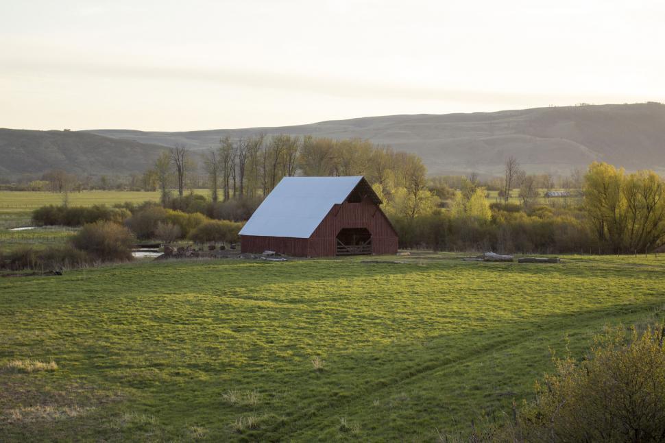 Free Image of Warm sunset over rustic countryside barn 