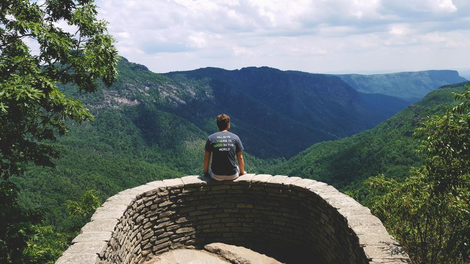 Free Image of Solitary man overlooking a vast mountain range 