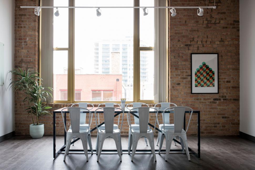 Co-working space with industrial-chic design elements, exposed brick walls, and modern furnishings