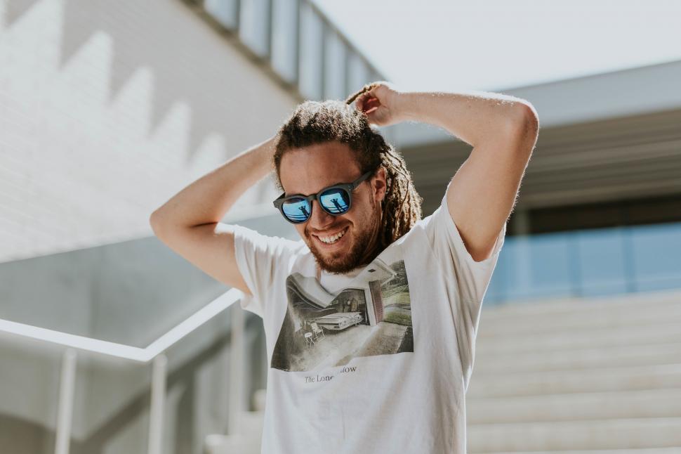 Free Image of Teenager outdoors with hands behind head 