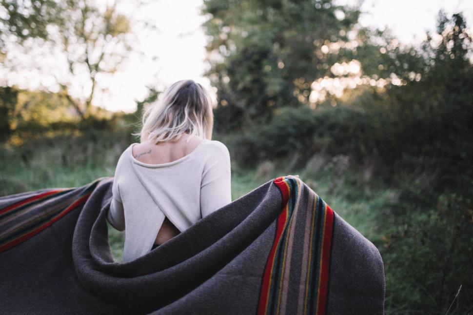 Free Image of Woman embracing herself in a nature setting 