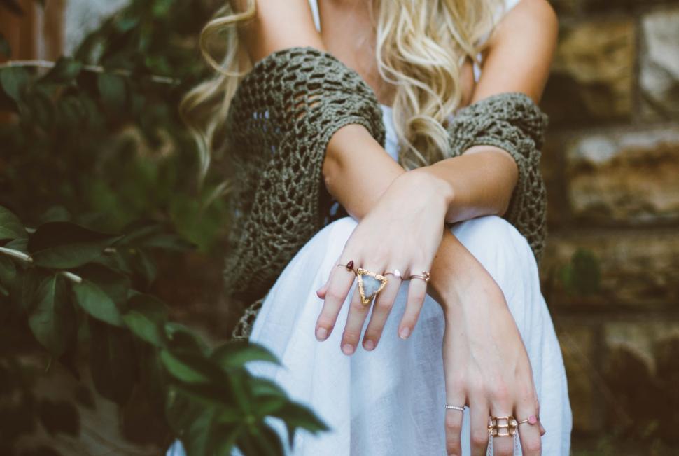 Free Image of Woman sitting elegantly surrounded by foliage 