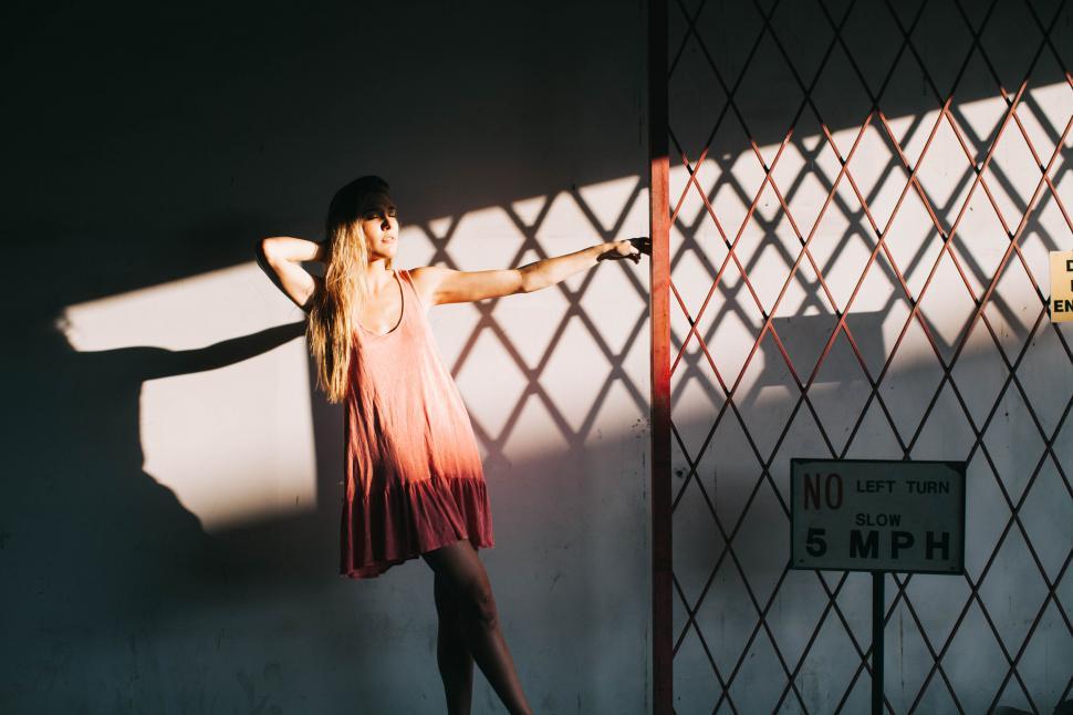 Free Image of Woman s silhouette against geometric shadows 