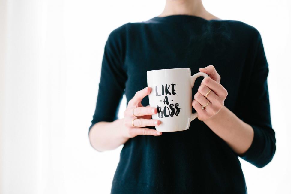 Free Image of Woman holding mug with empowering quote 