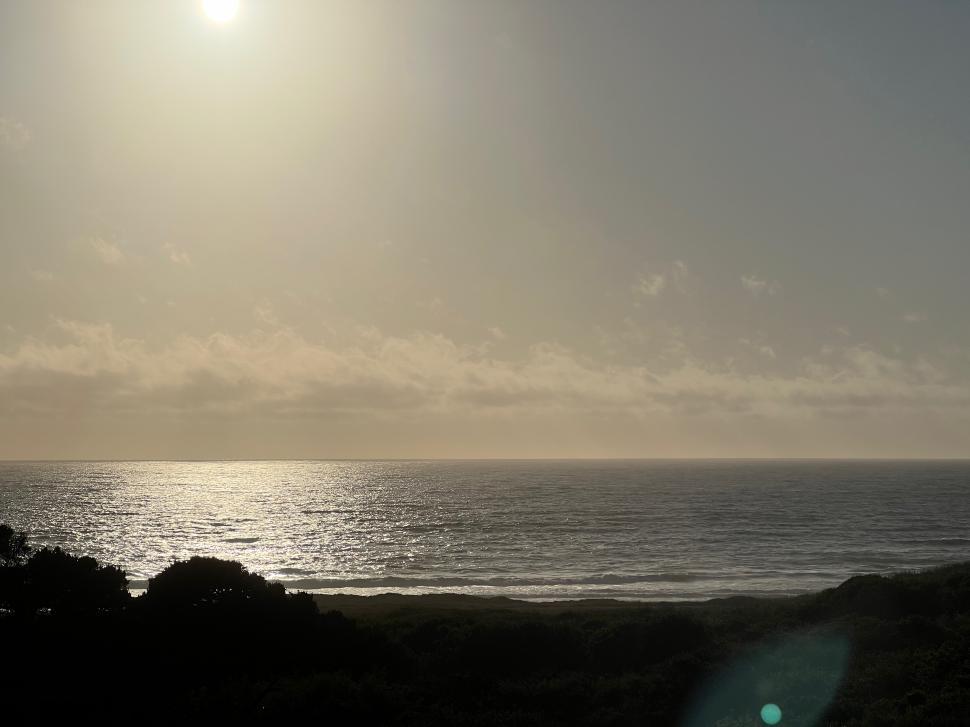 Free Image of Sunset over a tranquil ocean landscape 