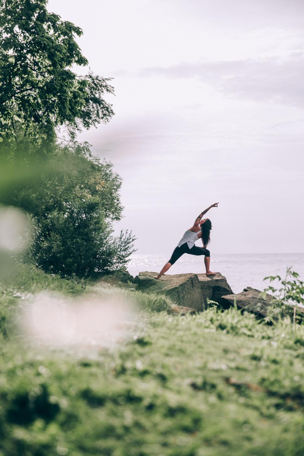 Free Image of Woman practicing yoga by the sea 