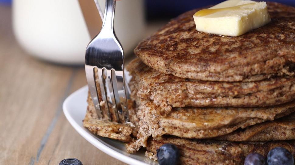 Free Image of Buttermilk pancakes stacked with butter on top 