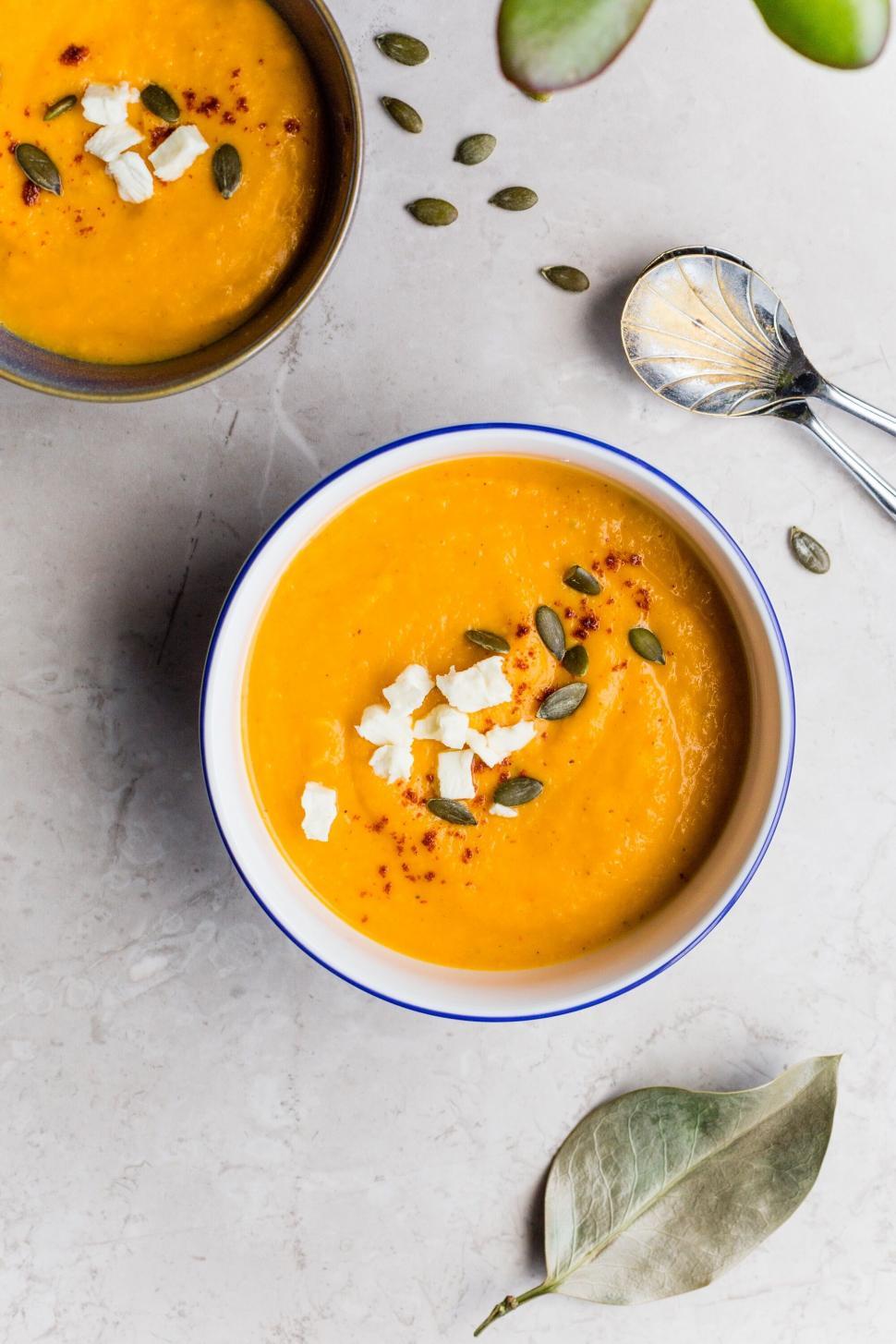 Free Image of Creamy pumpkin soup in a blue-rimmed bowl 