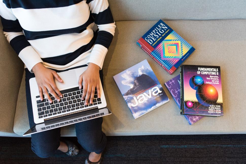 Free Image of Student studying with technology and textbooks 