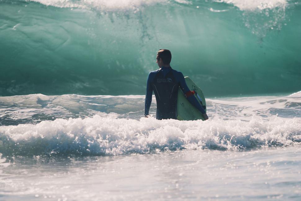 Free Image of Surfer watching the waves at the beach 