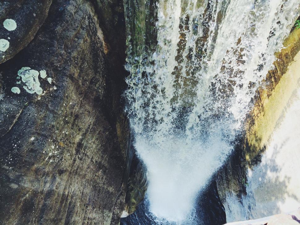 Free Image of Cascading waterfall over weathered rocks 