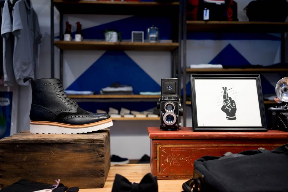 Free Image of Vintage camera next to framed graphics in store 