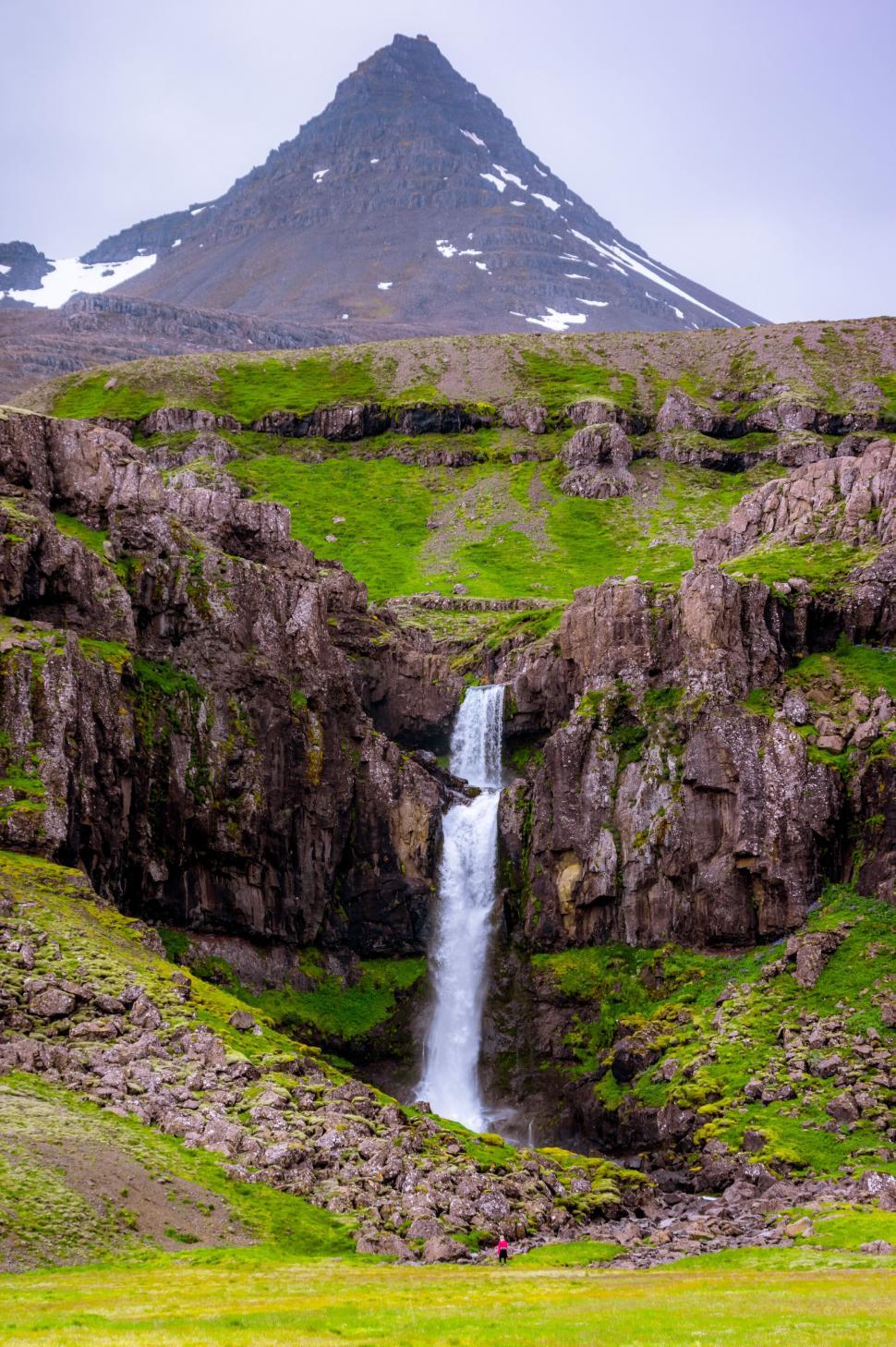 Free Image of Verdant cliff and waterfall under a mountain 