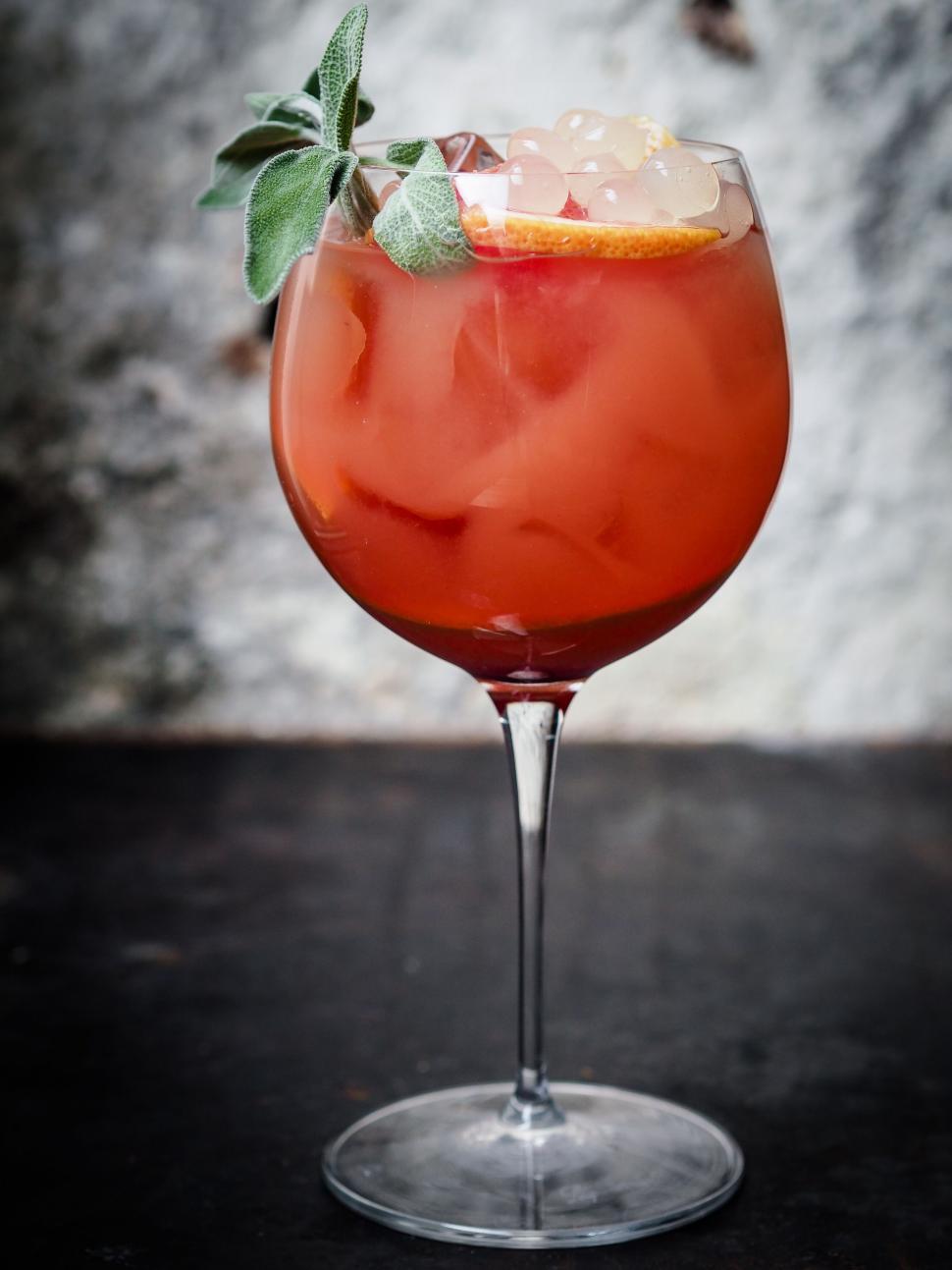 Free Image of Cocktail glass with orange beverage and garnish 